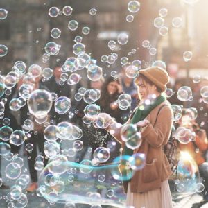 Woman blowing bubbles